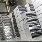 large stack of aluminum extruded heat sinks used by many different industries