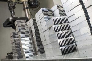 large stack of aluminum extruded heat sinks used by many different industries