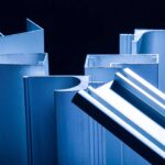 closeup of aluminum extruded profiles with custom designs coated in blue paint