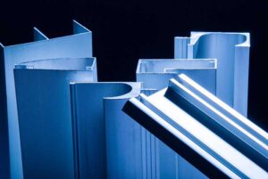 closeup of aluminum extruded profiles with custom designs coated in blue paint