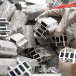 gloved worker holding a detailed custom aluminum extrusion profile
